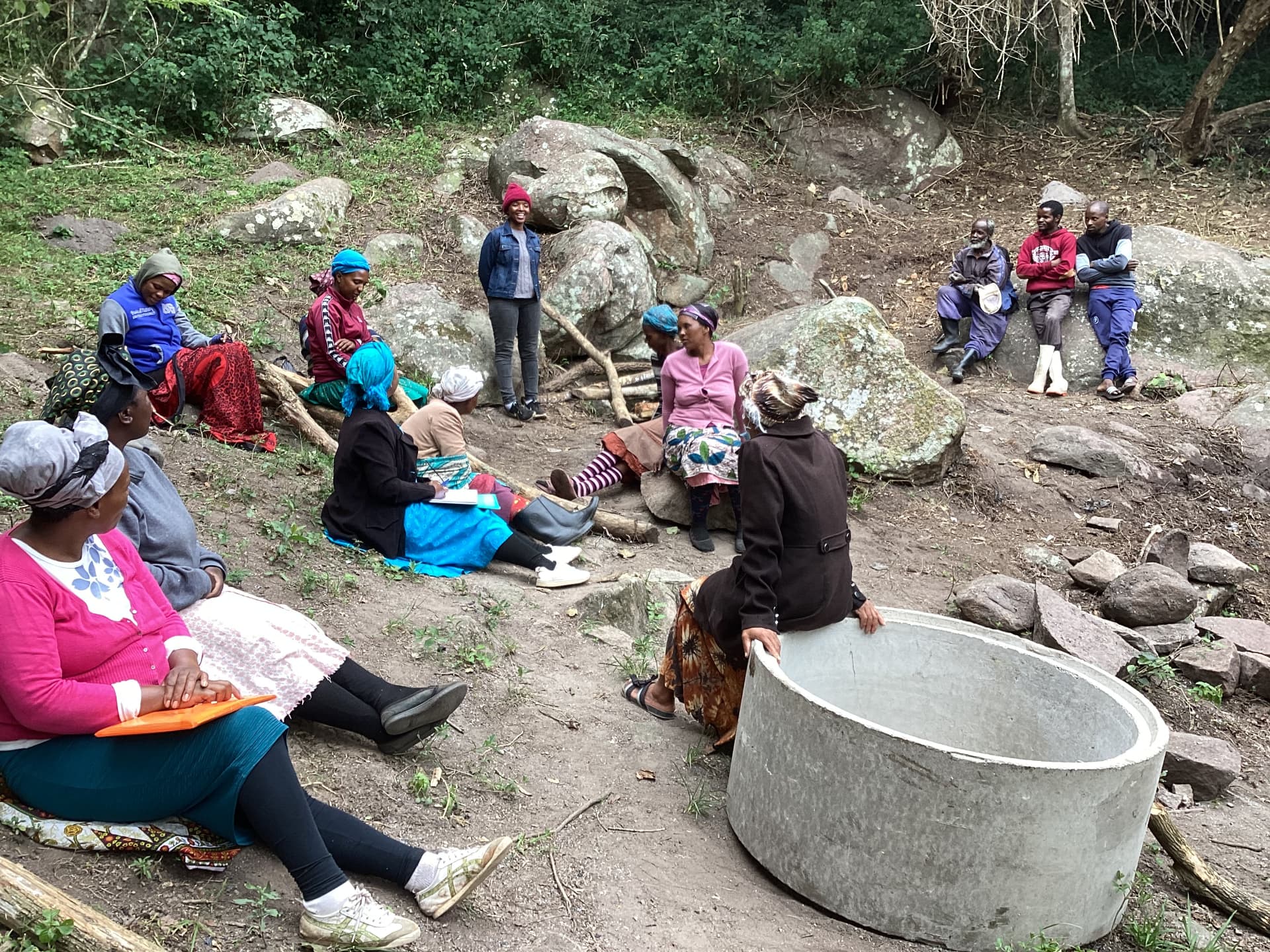 Community meeting beside a newly built water tank during a climate volunteering session in Eswatini